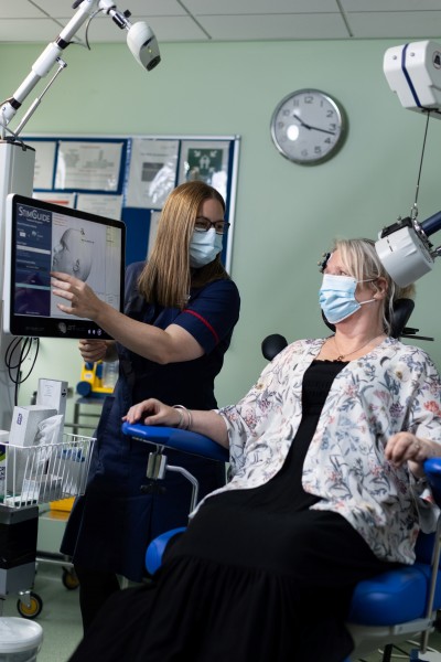 Sharon receiving TMS treatment from nurse